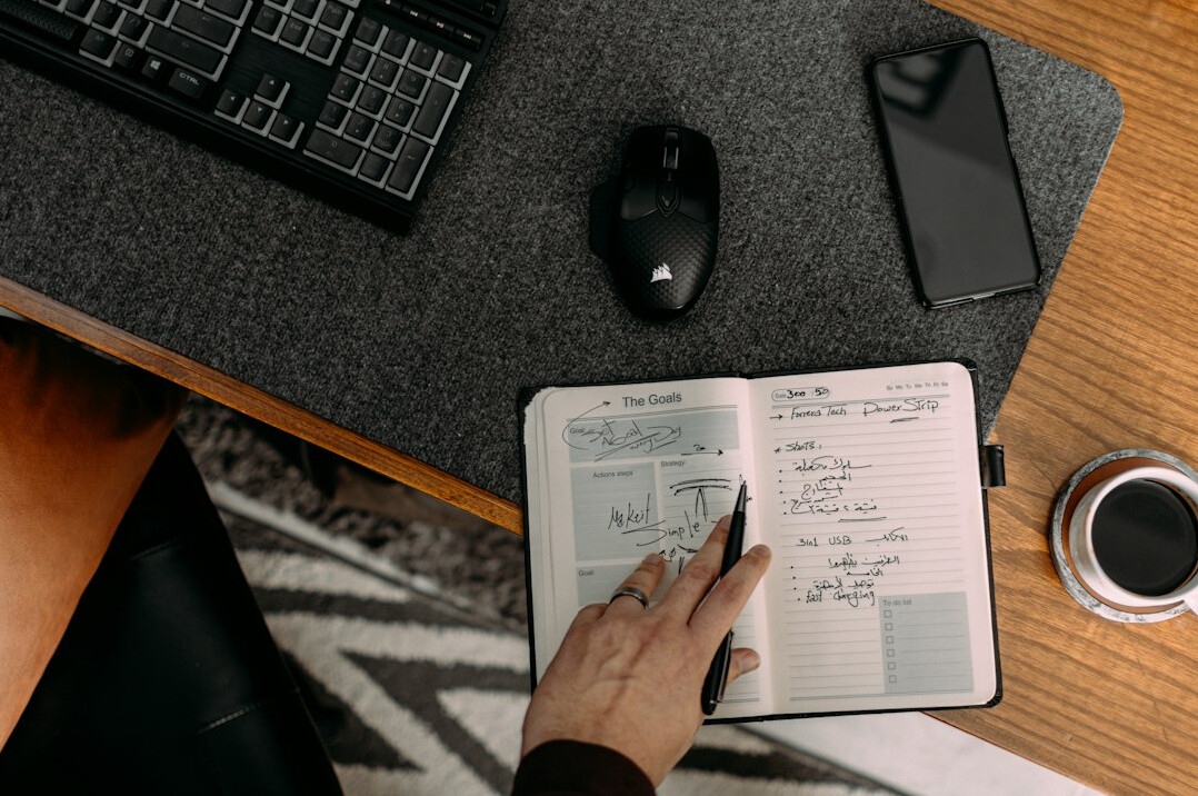 person tracking expenses on notebook