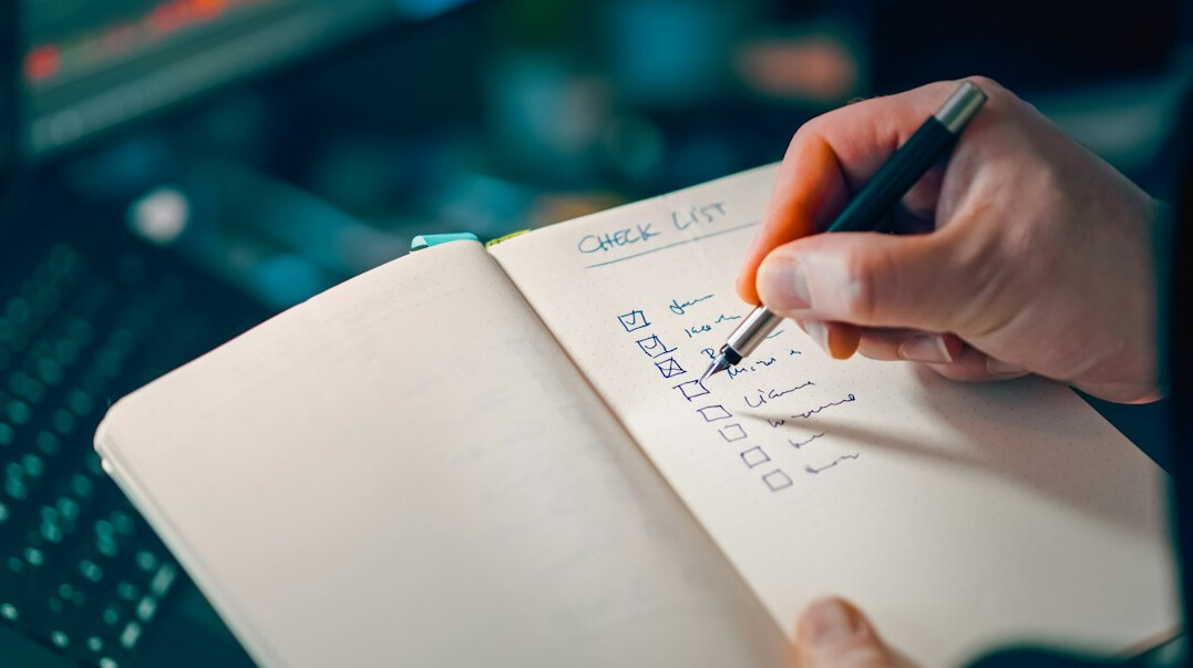 person tracking expenses on notebook